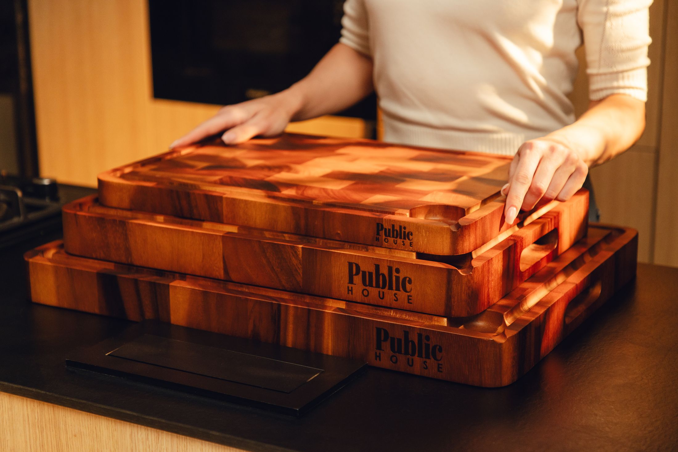 Three sizes of Public House boards stacked on a kitchen bench